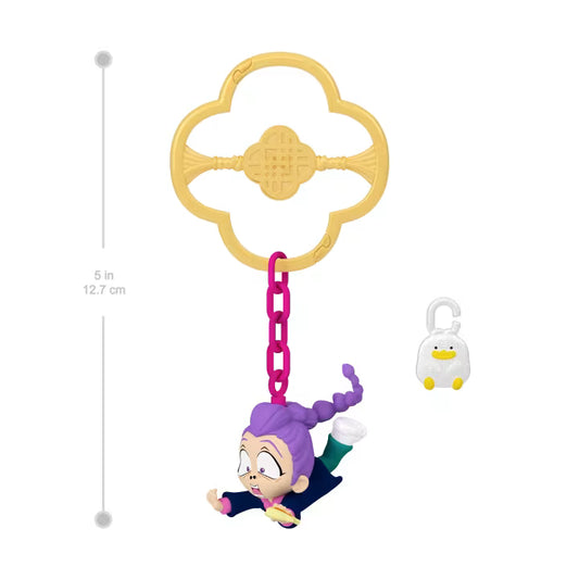Toy figure with purple hair and a penguin on a white background