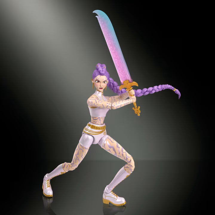 A stylized female action figure posed in a dynamic combat stance, holding a large sword with a blue-to-pink gradient blade and gold hilt. The figure has purple braided hair, pale skin with tan markings, and white-and-gold shoes, set against a dark gradient background with spotlighting.