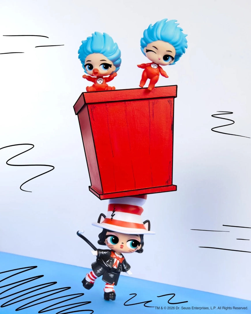 A stylized collectible figure of a black cat in a red-and-white striped hat balancing a red box with two small blue-haired characters on top, shown on a white background with hand-drawn black motion lines.