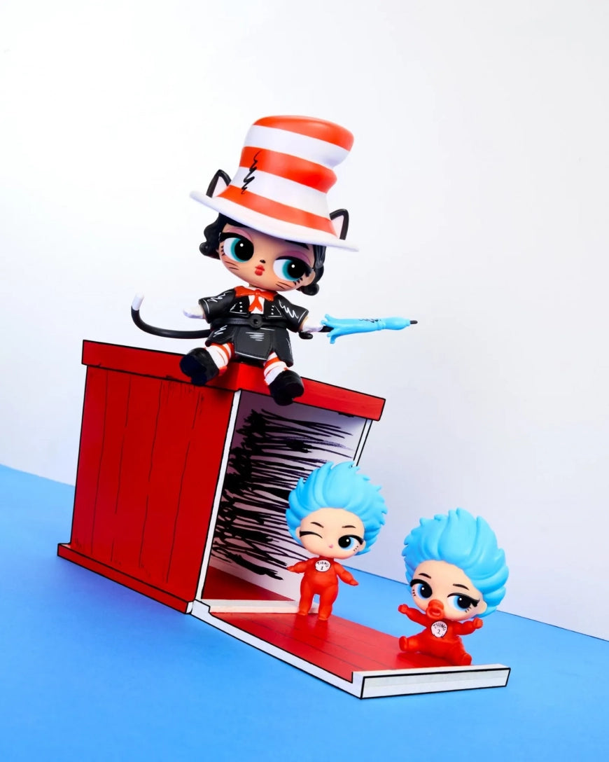 A Dr. Seuss-themed toy set featuring a black cat figurine wearing a red and white striped hat and suit, sitting on top of a red crate.