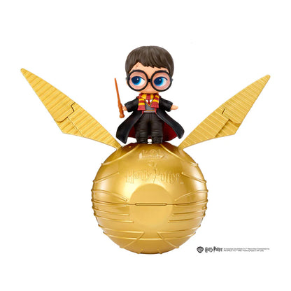 Harry Potter Golden Snitch figure with a small Harry character standing on top of a gold-colored spherical巢 with large golden wings, shown against a plain white background.