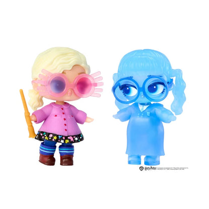 Two small character figurines on a plain white background. One figure has blonde hair, pink sunglasses, a pink top, and a dark floral skirt, holding a yellow wand.
