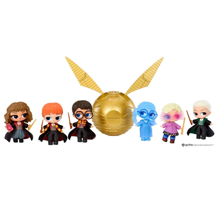 A set of Harry Potter surprise toy figures and a golden snitch, including Hermione, Ron, Harry, Ginny, Luna, Draco, and Dumbledore, arranged in a row with a large gold glittery snitch in the center on a white background.