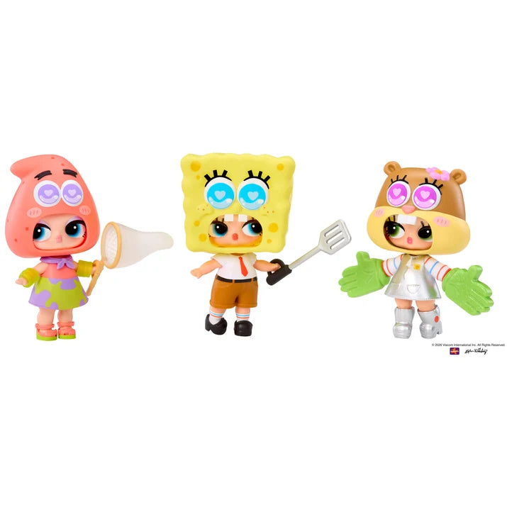 Three small character figurines on a plain white background: a pink creature holding a net on the left, a yellow sponge-like character holding a spatula in the center, and a brown animal character with green gloves on the right. A small copyright/brand mark appears at the lower right.