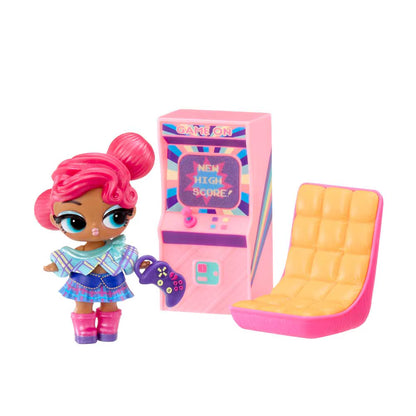 A pink doll with bright pink hair stands next to a pink arcade machine and a pink-and-yellow chair on a plain white background.