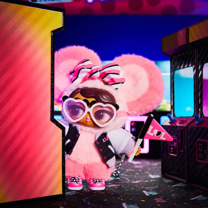 Pink plush toy with goggles and a microphone on a colorful background