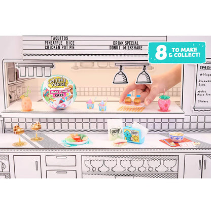 Toy cafe set with miniature food items and a hand interacting with it, on a white background.