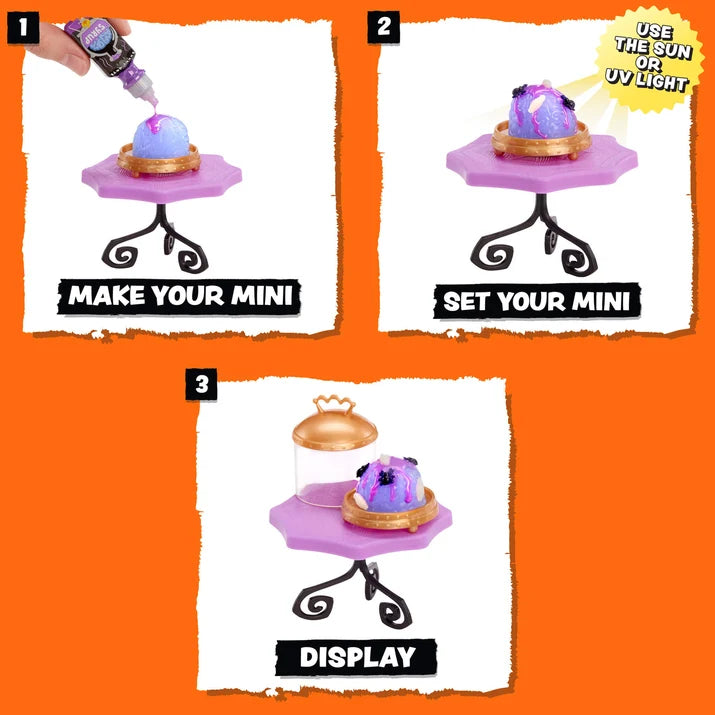 Three-panel instruction graphic showing how to display a mini collectible figurine: step 1 shows a hand applying purple glitter from a tube, step 2 shows the decorated mini on a small purple stand, and step 3 shows the final display with a glass dome lid. The background is bright orange.