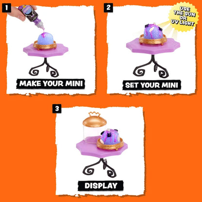Three-panel instruction graphic showing how to display a mini collectible figurine: step 1 shows a hand applying purple glitter from a tube, step 2 shows the decorated mini on a small purple stand, and step 3 shows the final display with a glass dome lid. The background is bright orange.
