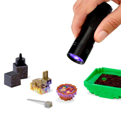 The ingredients for the Miniverse Rabbit Stew set revealed under a UV light, including a square bowl, resin stew, and a tiny blocky Rabbit figure.