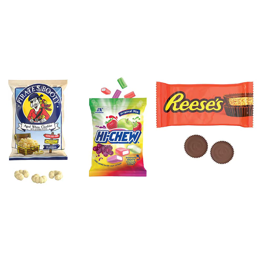 A collection of candy and snack products arranged on a plain white background, including a bag of Pirate's Booty Apple White Chocolate chips, a bag of Hi-Chew Melters candy, and two Reese's cups with two Reese's butter cups below.