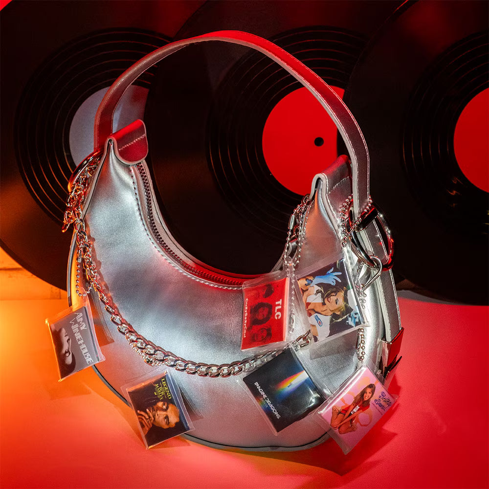 A hot pink mystery blind pack ball for MGA's Miniverse Real Music Vinyl surrounded by mini playable vinyl records, sleeves, and crates.