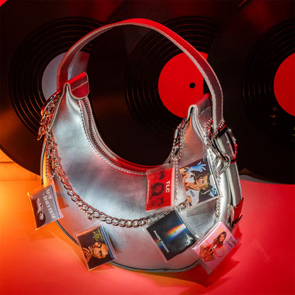 A hot pink mystery blind pack ball for MGA's Miniverse Real Music Vinyl surrounded by mini playable vinyl records, sleeves, and crates.