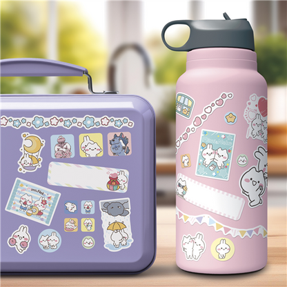 Purple lunch box and pink water bottle with cartoon designs on a blurred background