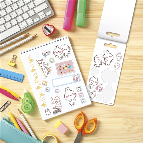 Sticker sheets with cute designs on a desk with stationery items