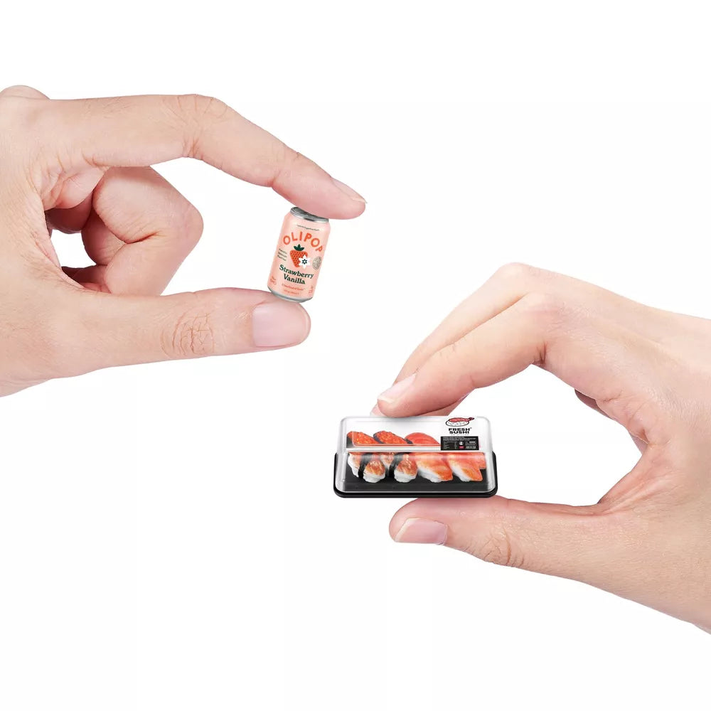 Two miniature food packages held between two hands against a white background