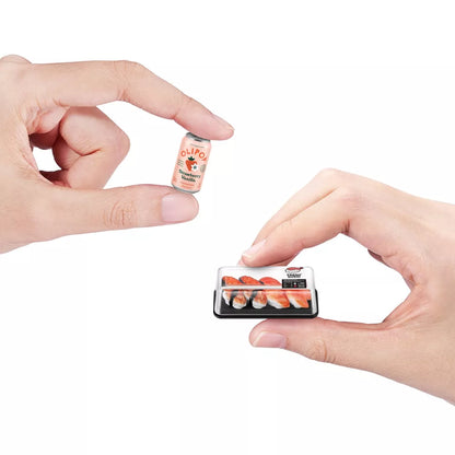 Two miniature food packages held between two hands against a white background