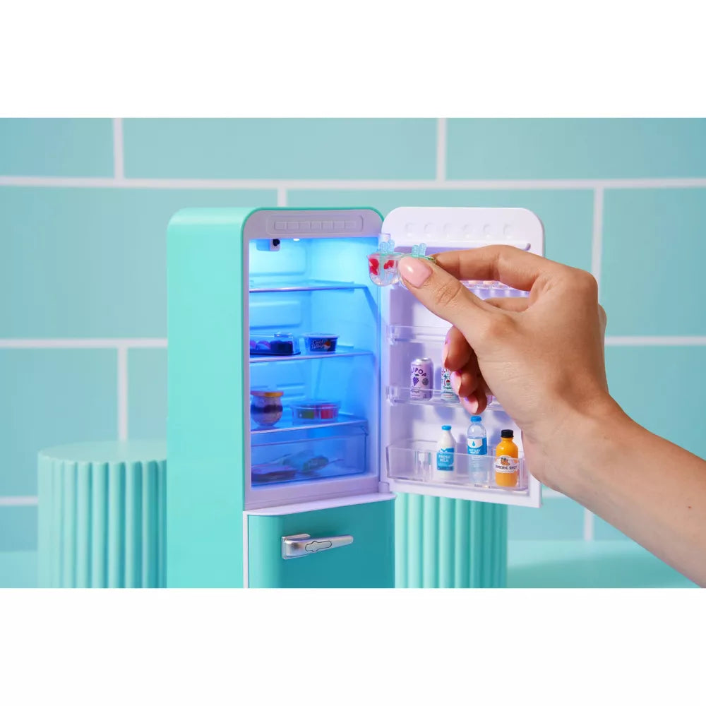 Hand opening a small refrigerator filled with items against a light blue tiled wall.