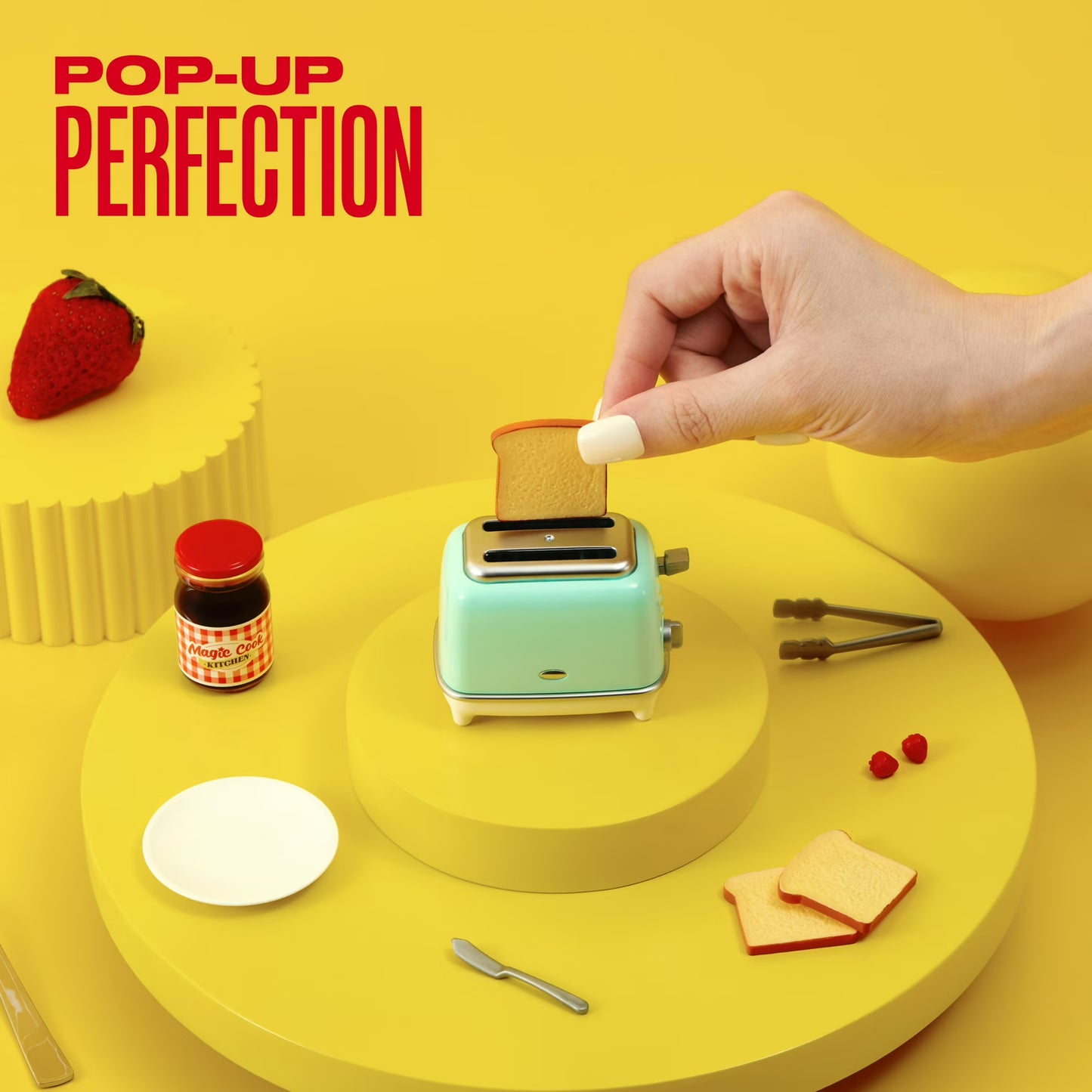 Miniature toaster with bread, jam, and a hand on a yellow background with 'Pop-Up Perfection' text.