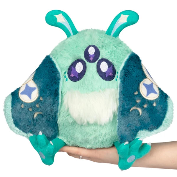 Mini Squishable Alien Mothman plush featuring mint green fur, three purple eyes, and patterned teal wings.