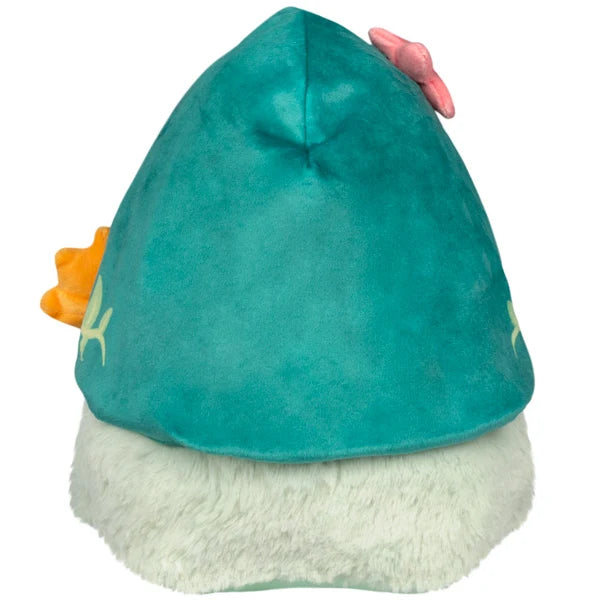Mini Squishable Botanical Plague Nurse plush with teal vine-embroidered hood, white beak, light green dress, and holding an orange flower.