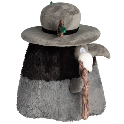 Side view of Mini Squishable Druid Plague Doctor plush in forest green robes with leafy details