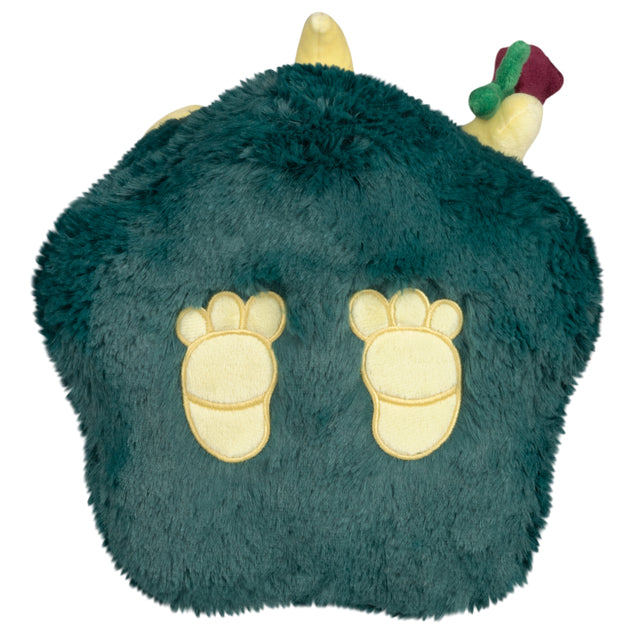 bottom of Mini Squishable Graveyard Plague Nurse plush with green cloak, skeleton embroidery, rose, and bat