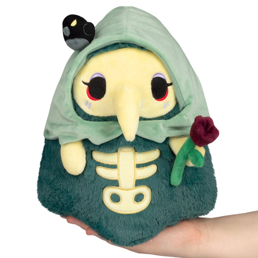 Mini Squishable Graveyard Plague Nurse plush with green cloak, skeleton embroidery, rose, and bat