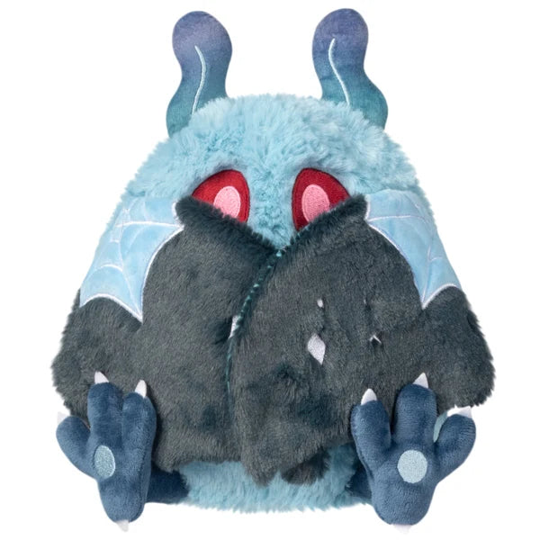 Mini Squishable Haunted Mothman plush featuring light blue fur, glowing red eyes, and dark tattered wings.