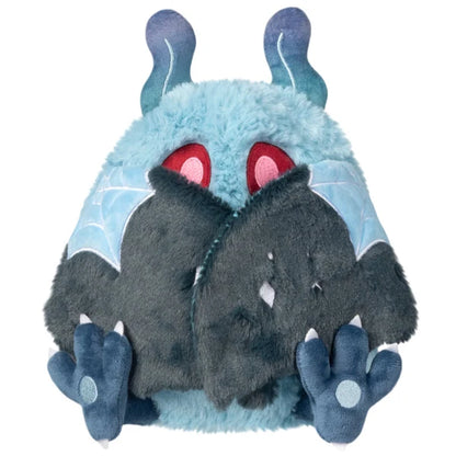 Mini Squishable Haunted Mothman plush featuring light blue fur, glowing red eyes, and dark tattered wings.