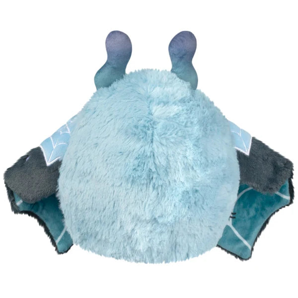 Mini Squishable Haunted Mothman plush featuring light blue fur, glowing red eyes, and dark tattered wings.
