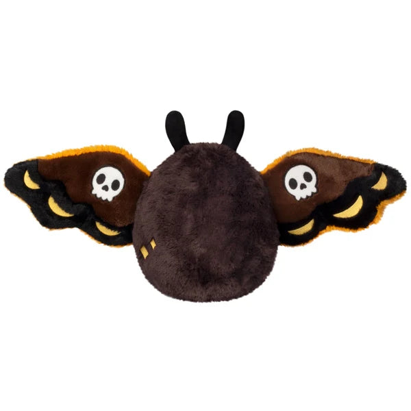 Mini Squishable Hawkmothman plush featuring dark brown fur, yellow eyes, and dark wings with skull patterns.