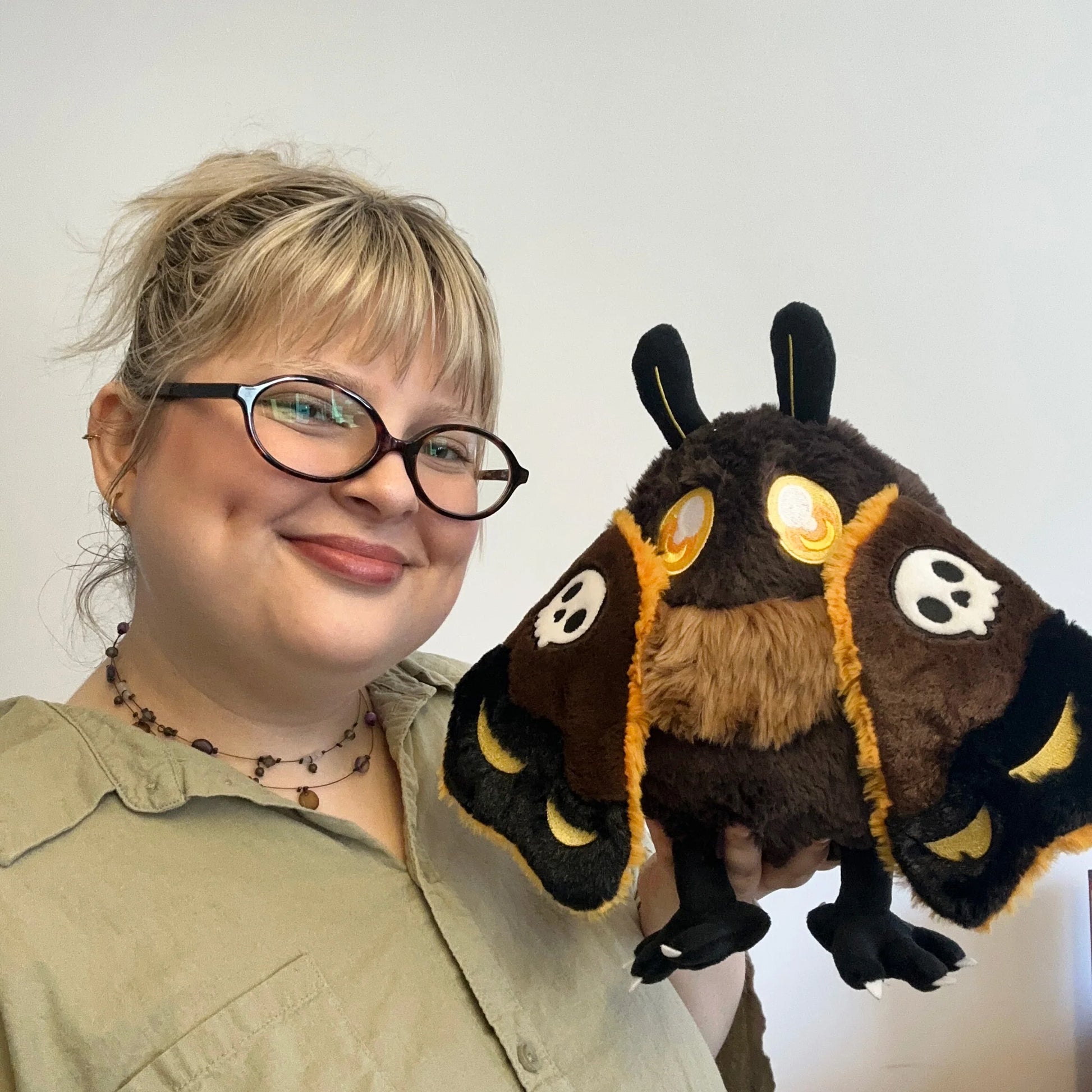 Person holding a plush toy with a white background