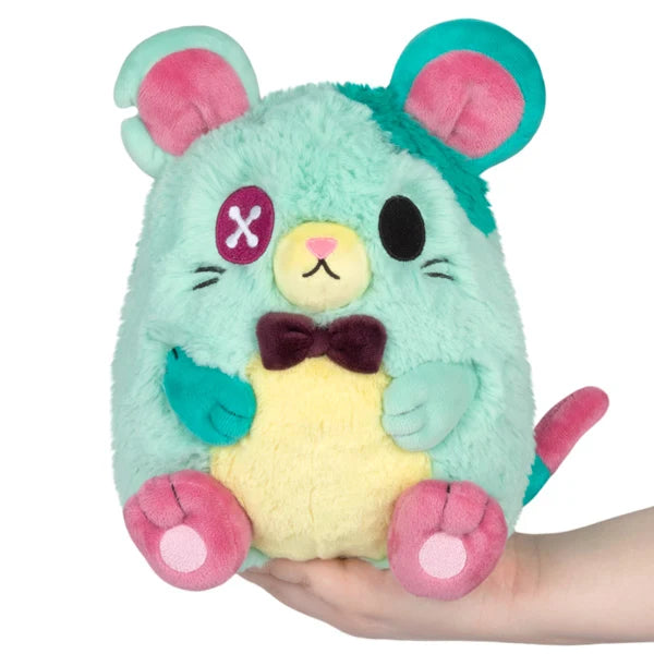 Mini Squishable Mori the Plague Rat plush featuring mint and teal fur, a pink paw accent, and a dark bow tie.