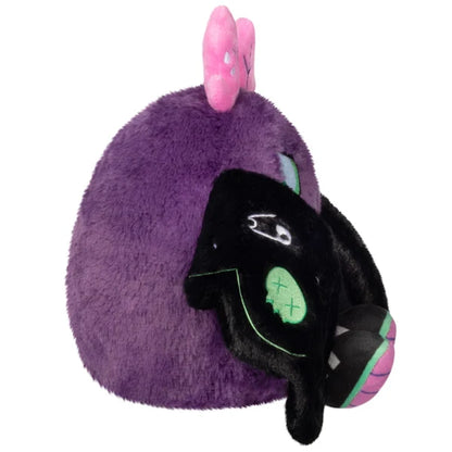 Mini Squishable Neon Punk Mothman plush with deep purple fur, neon pink antennae, bright green eyes, and patch-embellished black wings.