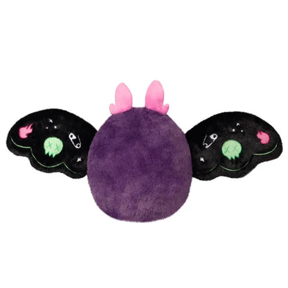 Mini Squishable Neon Punk Mothman plush with deep purple fur, neon pink antennae, bright green eyes, and patch-embellished black wings.