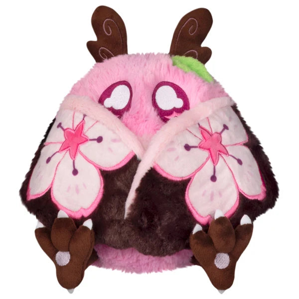 Mini Squishable Sakura Mothman plush with a pink body, fluffy white belly, brown antennae, and pink wings featuring cherry blossom designs.
