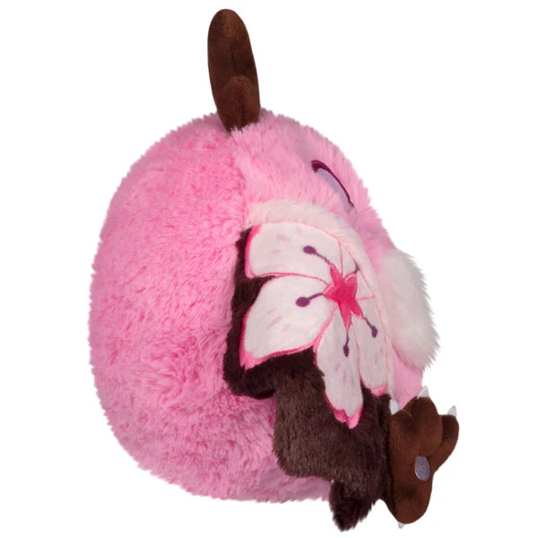 Mini Squishable Sakura Mothman plush with a pink body, fluffy white belly, brown antennae, and pink wings featuring cherry blossom designs.