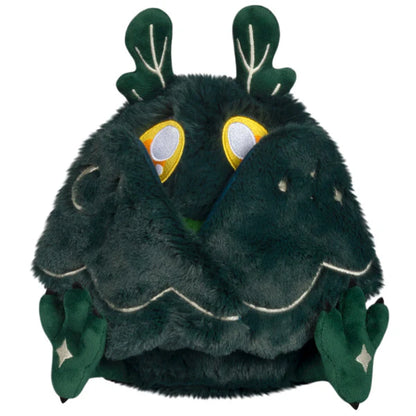 Squishable Mini Dark Forest Mothman 9-Inch Plush, a dark green cryptid soft toy with bright green chest fluff and starry forest pattern wings