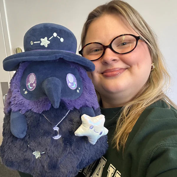 Squishable Mini Midnight Plague Doctor 11-Inch Plush, an indigo blue soft toy with a constellation hat and a crescent moon necklace