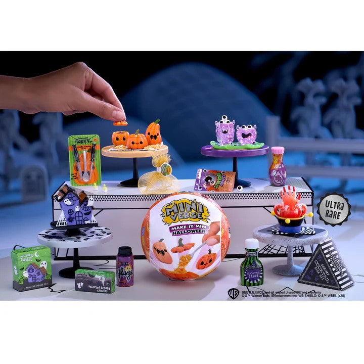 Halloween-themed toy set with various small figures and props on a table.  Miniverse Make it Mini Halloween Series 3.