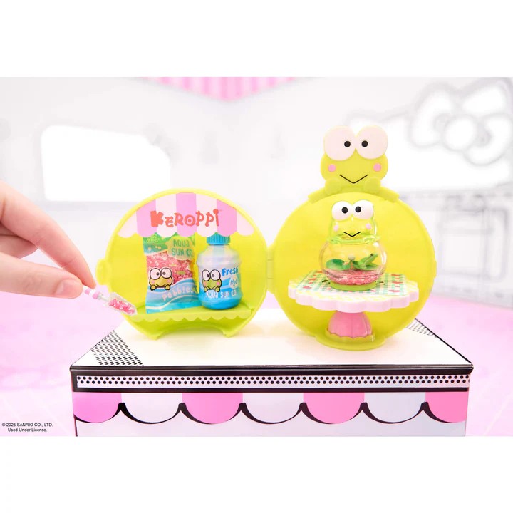 Yellow character with a small table and two bottles on a white background. Miniverse Make It Mini Hello Kitty Series 2.