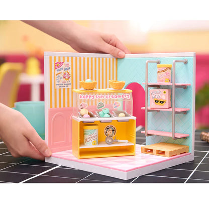 Small toy ice cream shop with a hand interacting with it on a tiled floor. Miniverse Spaces Ice Cream Shop Starter Pack display set Canada