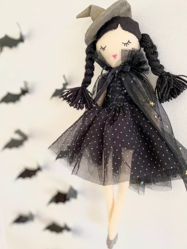 Mon Ami Cassandra Witch Doll wearing a black star-glitter tulle cape, metallic witch hat, and silver shoes.