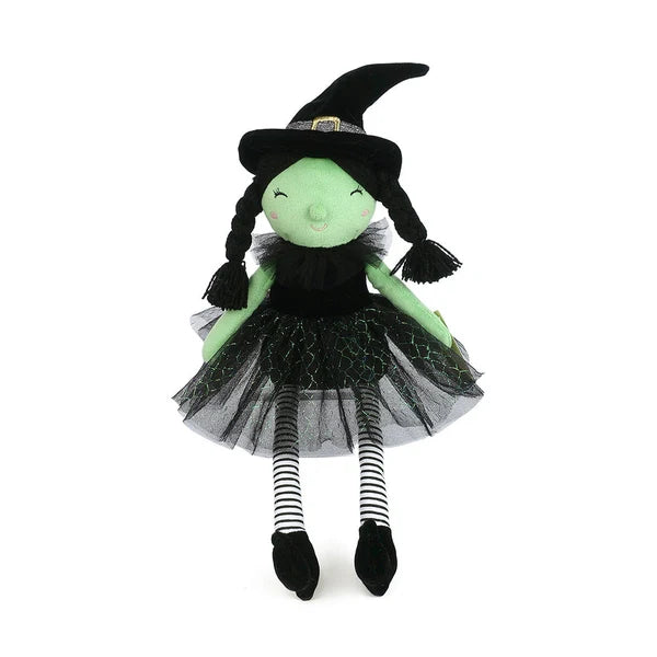 Mon Ami Esmerelda Witch doll featuring green plush skin, black yarn pigtails, a black tulle skirt, and striped leggings.