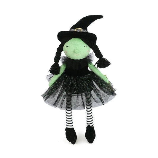 Mon Ami Esmerelda Witch doll featuring green plush skin, black yarn pigtails, a black tulle skirt, and striped leggings.