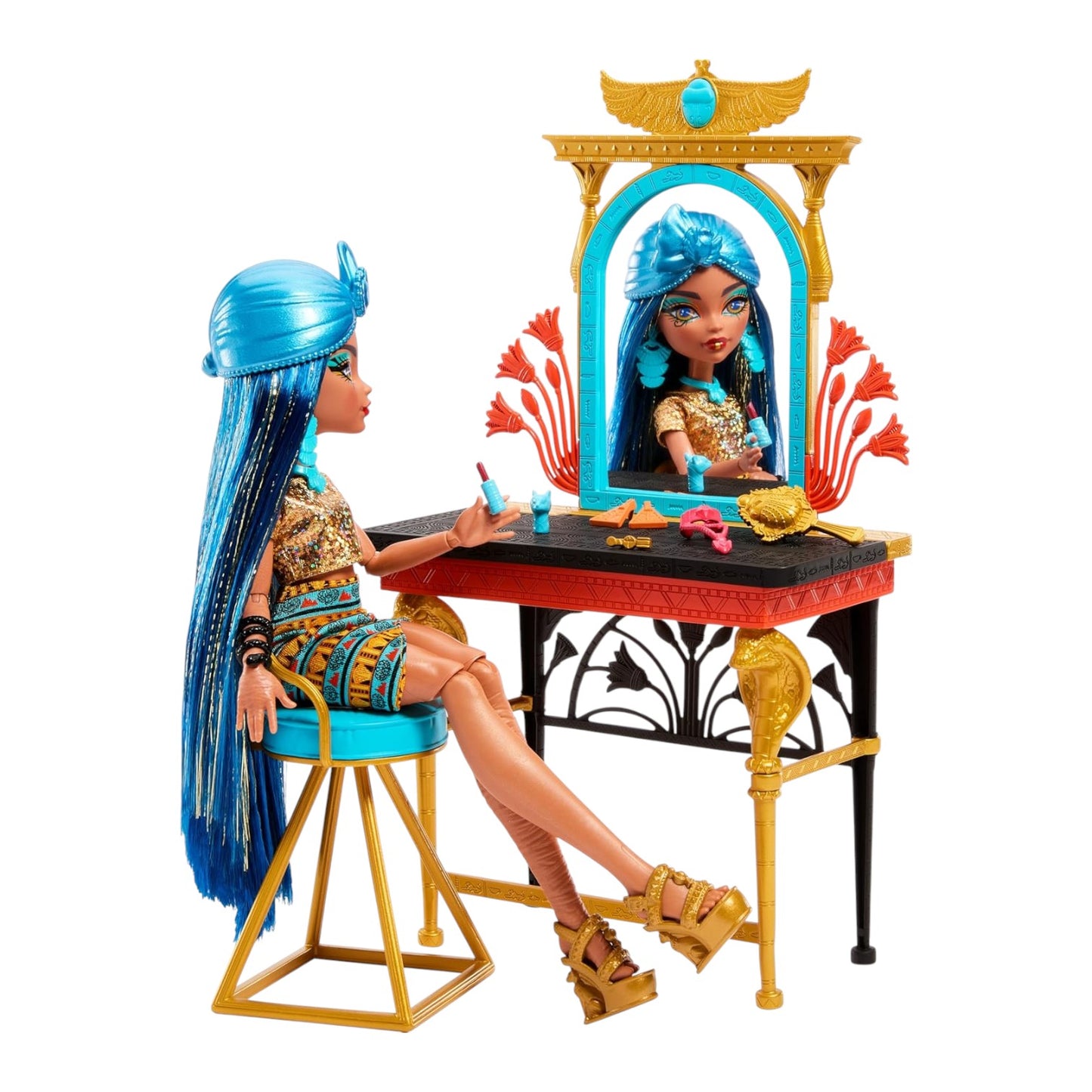 Toy doll with blue hair sitting at a vanity table with mirror