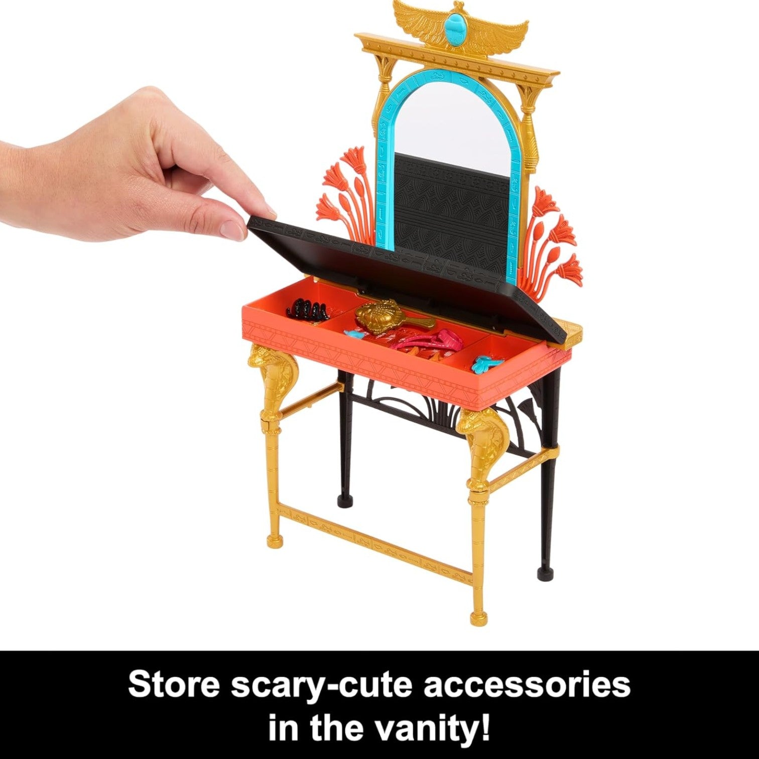 Toy vanity with mirror and drawers, hand opening one of the drawers.