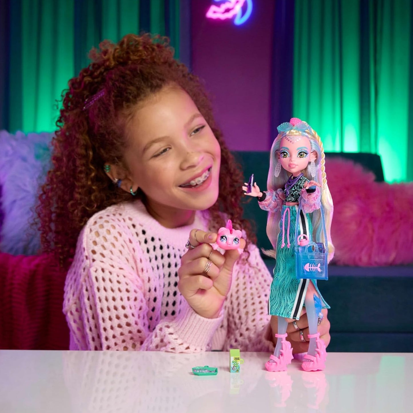 Child playing with a Monster High Lagoona Blue Core Refresh doll in a colorful room