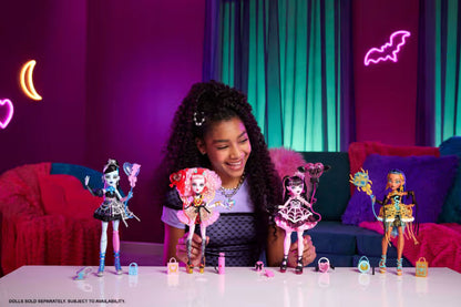 Girl playing with Monster High dolls in a colorful room